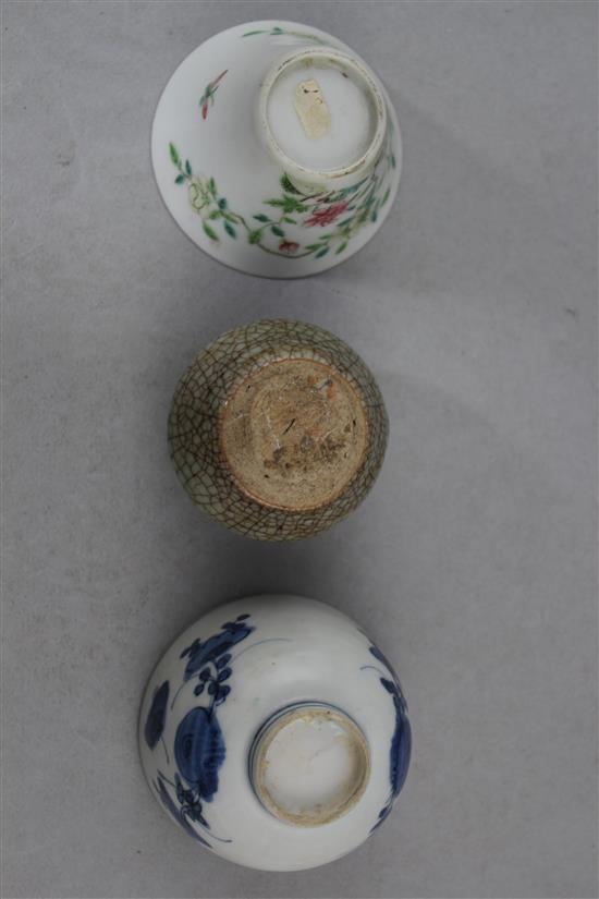 Two Chinese porcelain cups and a small crackle glaze vase, 17th - 19th century, 4.8cm., with wood stand